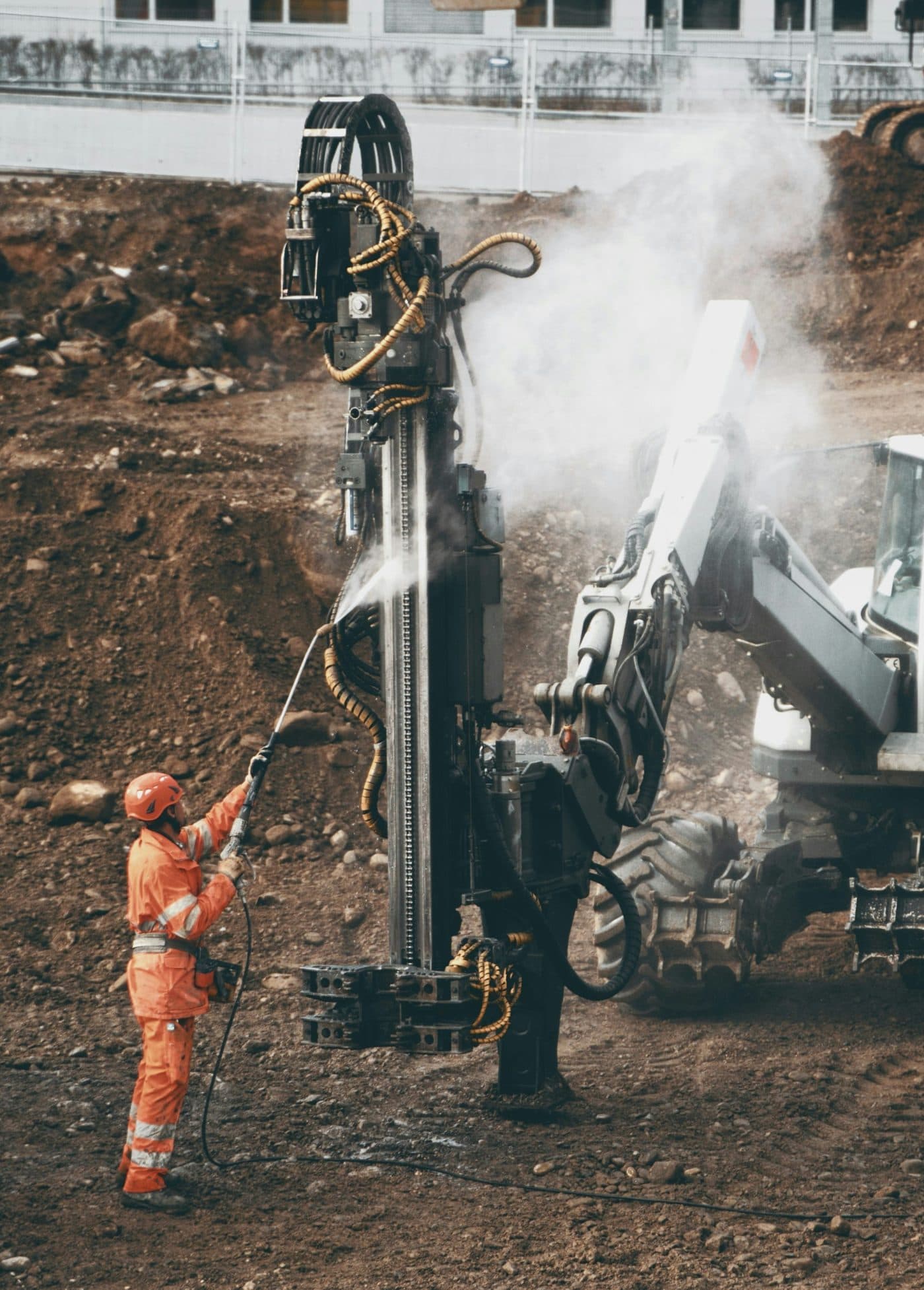 A ticketed artisan operating a rock drill underground.
