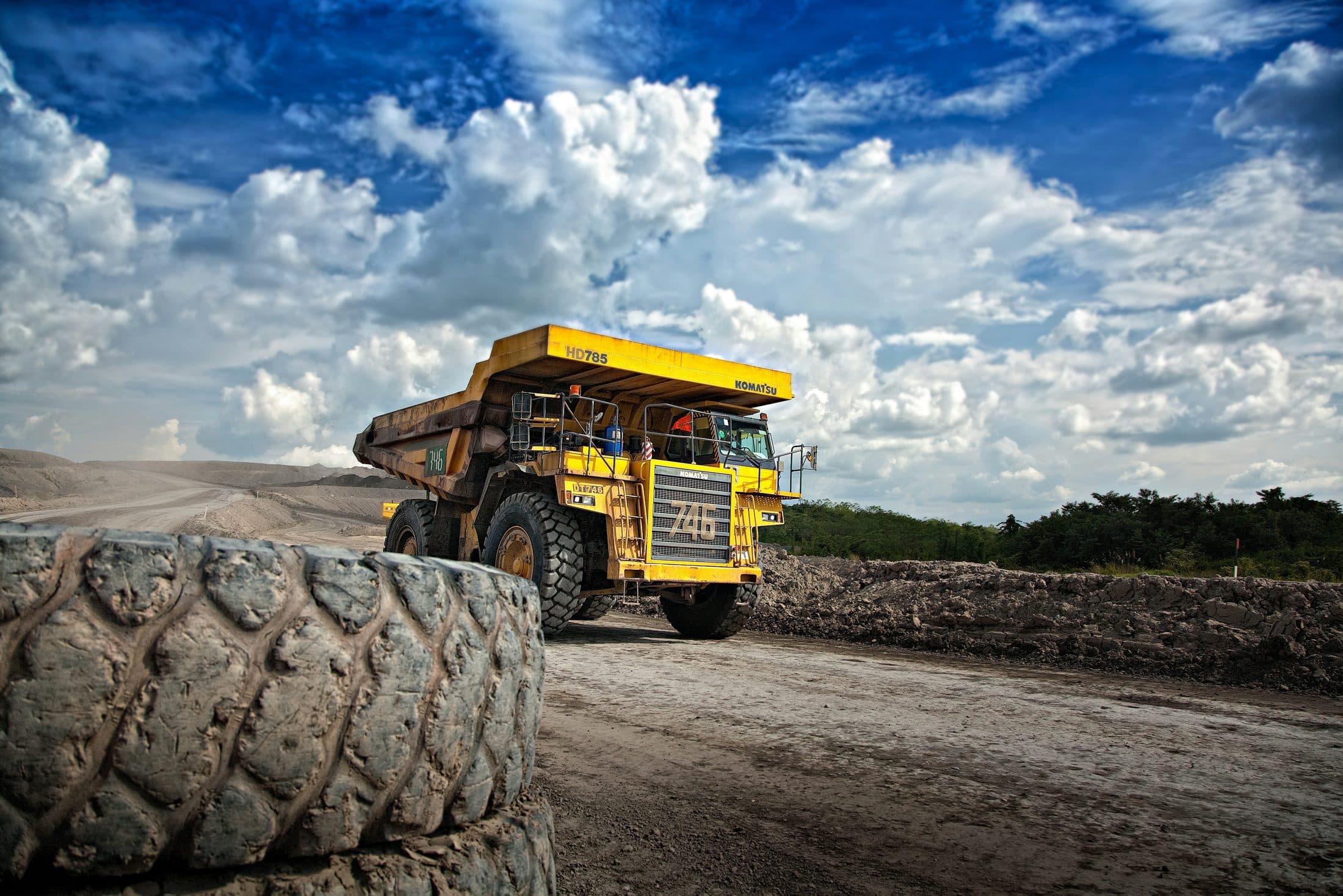 A haul truck working a mine under a clear blue sky.